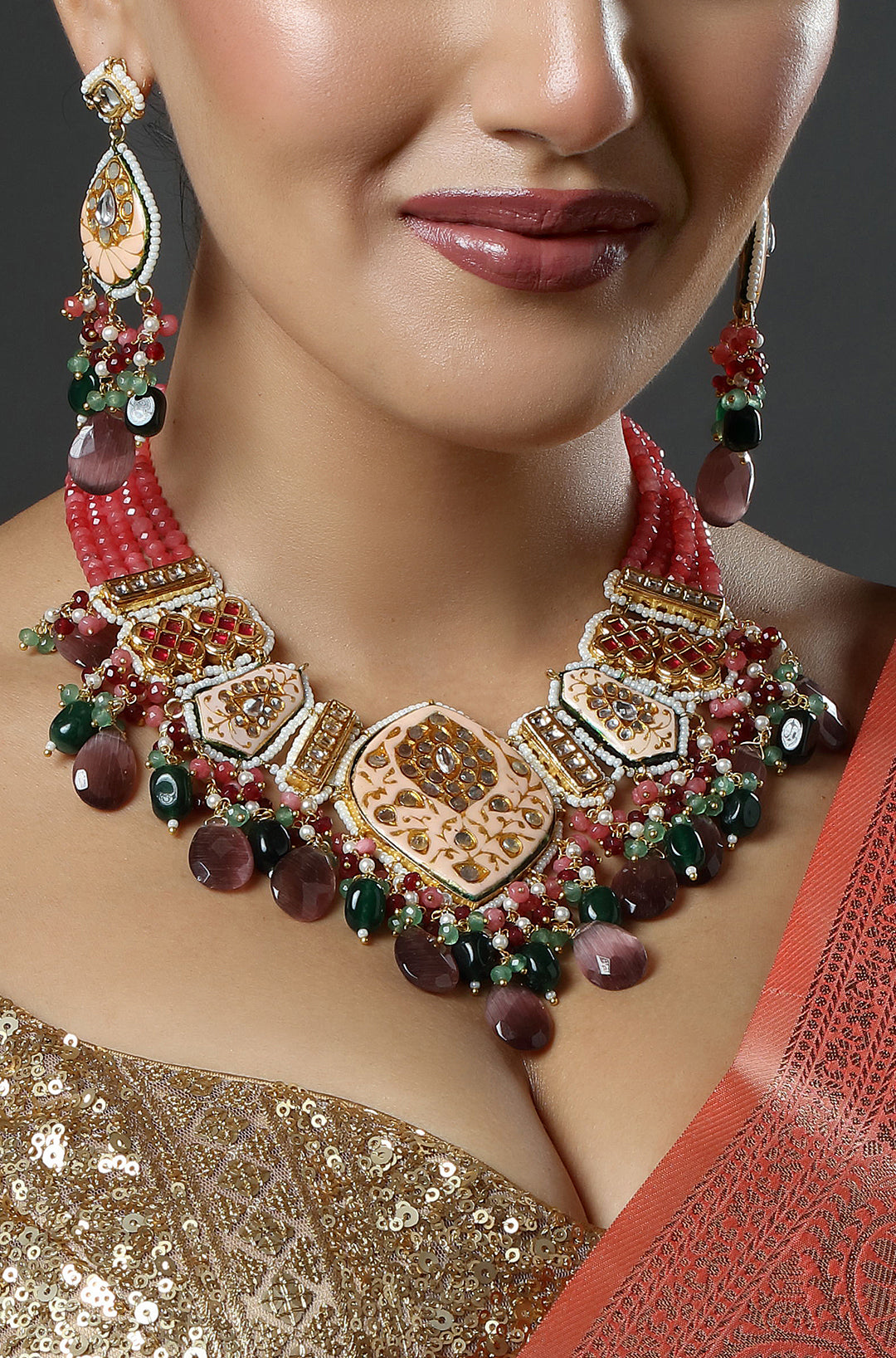 Close-up of a woman wearing an ornate necklace and earrings with a neutral background